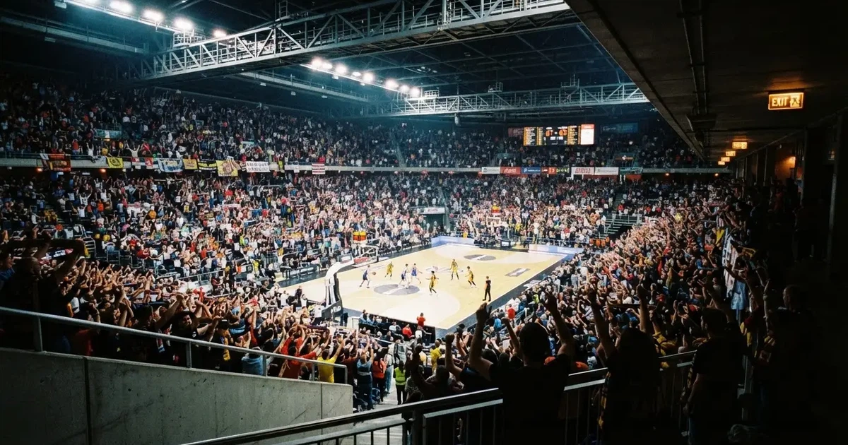 Un pabellón deportivo lleno bajo los focos, fotografiado desde muy lejos